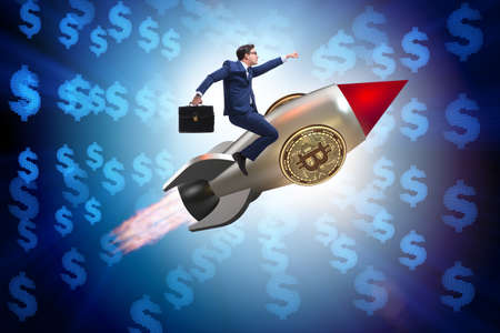 Businessman flying on rocket in bitcoin price rising conceptの写真素材
