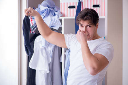 Man helpless with dirty clothing after separating from wifeの写真素材