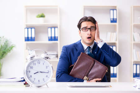 Businessman in rush trying to meet deadlineの写真素材