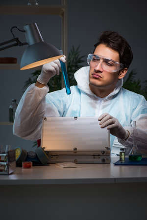 Forensic investigator working in lab looking for evidenceの写真素材