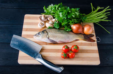 Uncooked fish on cutting board in meal preparation concept
