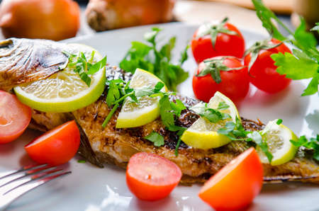 Fried fish served on the plateの写真素材