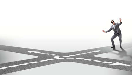 Young businessman at crossroads in uncertainty conceptの写真素材