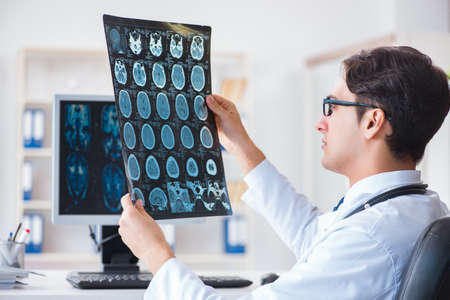 Doctor radiologist looking at x-ray imagesの写真素材