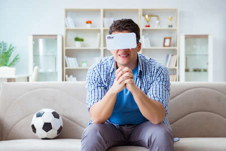 Man wearing virtual reality VR glasses watching soccer football