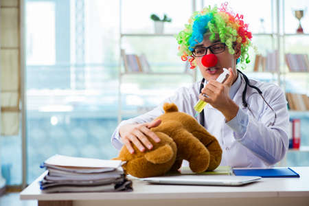 Funny pediatrician with toy in the hospital clinicの写真素材
