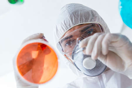 Chemist working in the laboratory with hazardous chemicals