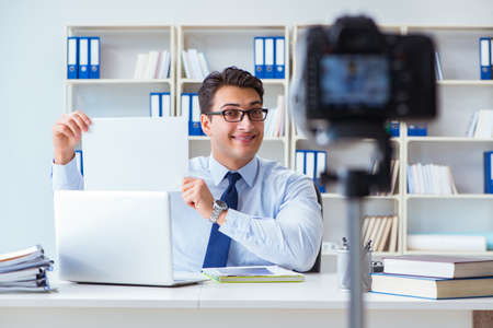 Business blogger doing webcast for his subscribersの写真素材