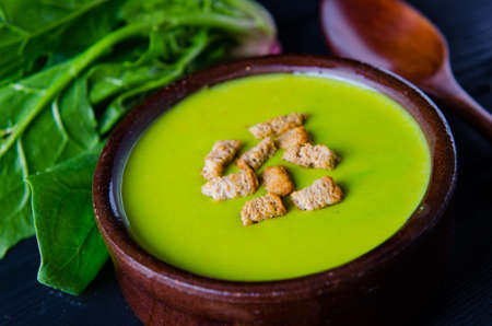 Spinach soup served on wooden board の写真素材