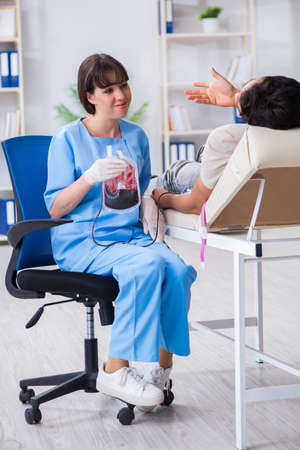 Patient getting blood transfusion in hospital clinicの写真素材