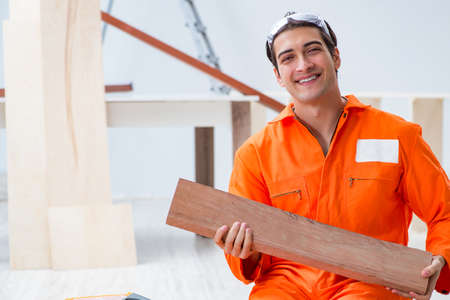 Contractor working on laminate wooden floorの写真素材