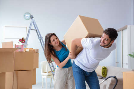 Young family unpacking at new house with boxesの写真素材