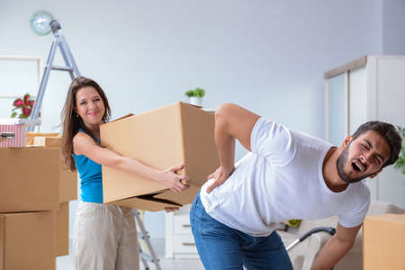 Young family unpacking at new house with boxesの写真素材