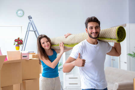 Young family unpacking at new house with boxesの写真素材