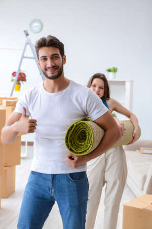Young family unpacking at new house with boxesの写真素材