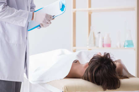 Police coroner examining dead body corpse in morgue
