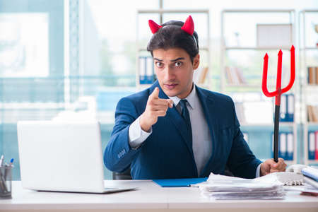 Devil angry businessman in the officeの写真素材