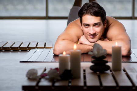 Young handsome man during spa procedureの写真素材