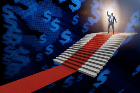 Young businessman climbing stairs and red carpetの写真素材