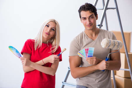 Young family doing painting job during home renovationの写真素材