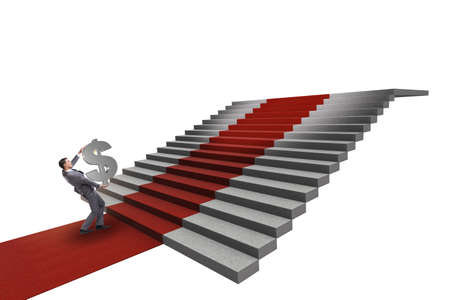 Young businessman climbing stairs and red carpet on white backgroundの写真素材