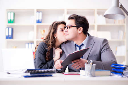 Happy couple working in the same officeの写真素材