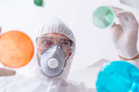 Chemist working in the laboratory with hazardous chemicals