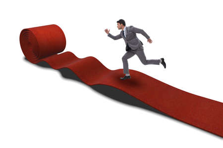 Businessman on red carpet isolated white backgroundの写真素材