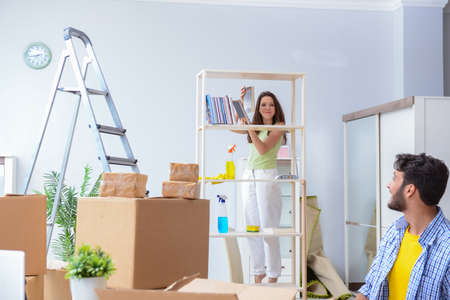 Young family unpacking at new house with boxesの写真素材