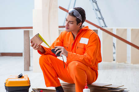 Contractor working on laminate wooden floorの写真素材