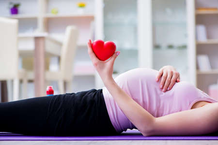 Pregnant woman exercising in anticipation of child birth