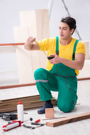 Contractor working on laminate wooden floorの写真素材