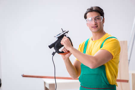 Contractor working on laminate wooden floorの写真素材