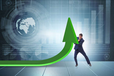 Businessman supporting growtn in economy on chart graphの写真素材