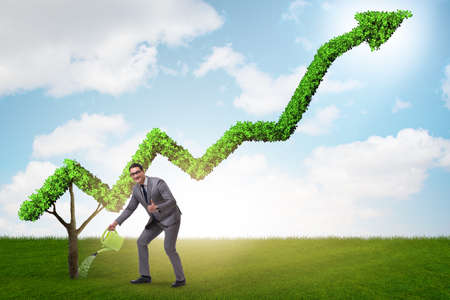 Businessman in investment concept watering financial line chartの写真素材