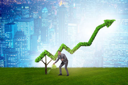 Businessman in investment concept watering financial line chartの写真素材