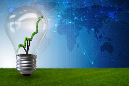 Green energy concept with green line graph in light bulbの写真素材