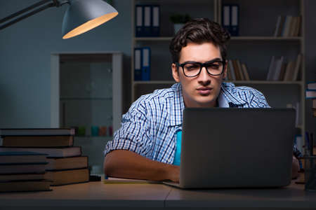 Student preparing for exams late night at homeの写真素材