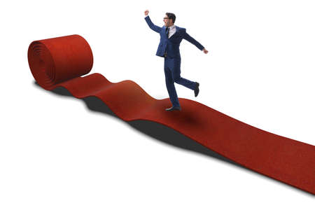 Businessman on red carpet isolated white backgroundの写真素材