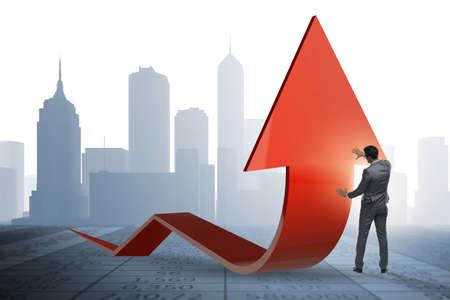 Businessman supporting growtn in economy on chart graphの写真素材