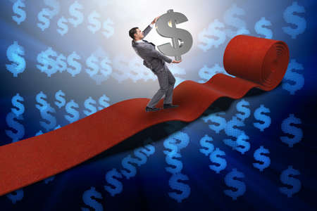 Businessman with dollars on red carpetの写真素材