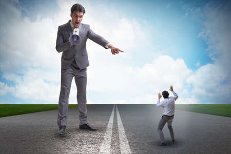 Bad angry boss shouting at employee with loudspeakerの写真素材