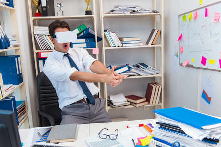 Employee watching movie on vr virtual reality glassesの写真素材