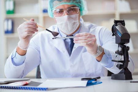 Forensics investigator working in lab on crime evidence