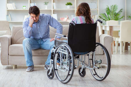 Desperate disabled person on wheelchairの写真素材