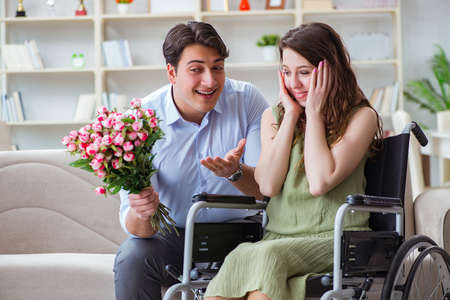 Man making marriage proposal to disabled woman on wheelchairの写真素材