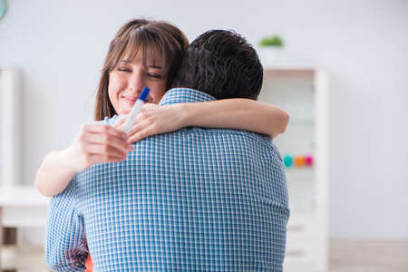 Wife and husband looking at pregnancy testの写真素材
