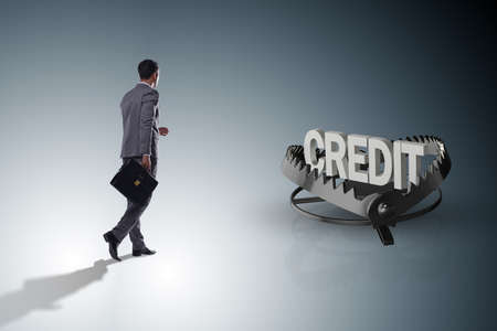 Businessman falling into the trap of loan creditの写真素材