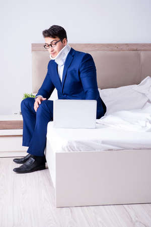 Businessman with neck injury working from homeの写真素材