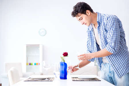 Man alone preparing for romantic date with his sweetheartの写真素材